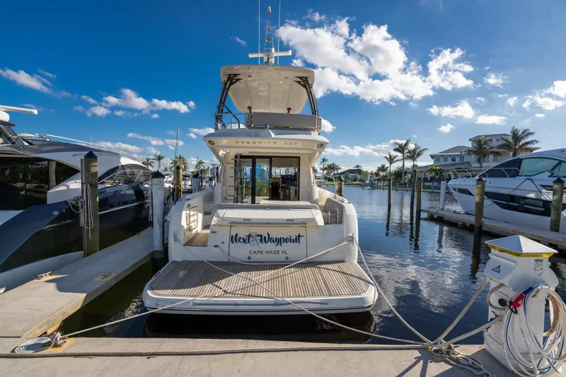 Next Waypoint Yacht Photos Pics Prestige 420 Flybridge yacht docked at marina, 2020 model, sunny day.