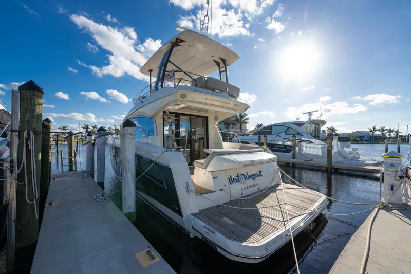 Next Waypoint Yacht Photos Pics 2020 Prestige 420 Flybridge yacht docked at marina under sunny sky.