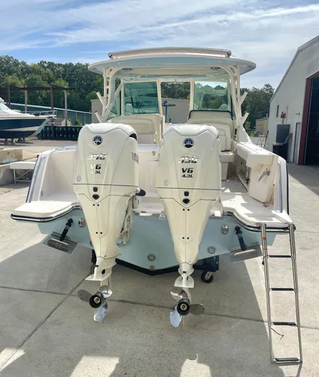  Yacht Photos Pics 2025 Grady-White Freedom 325 boat with twin Yamaha V6 engines, docked outdoors.