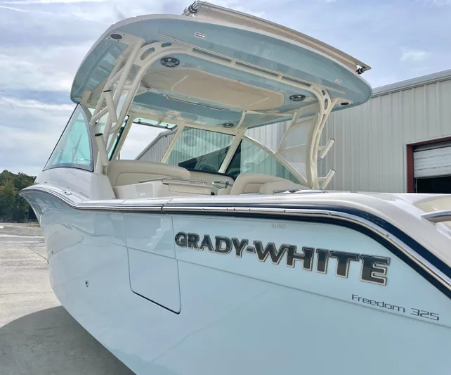 Yacht Photos Pics 2025 Grady-White Freedom 325 boat, sleek design, docked outdoors.