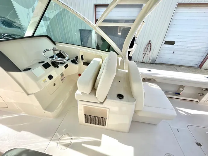  Yacht Photos Pics 2025 Grady-White Freedom 325 boat interior with helm and seating area.