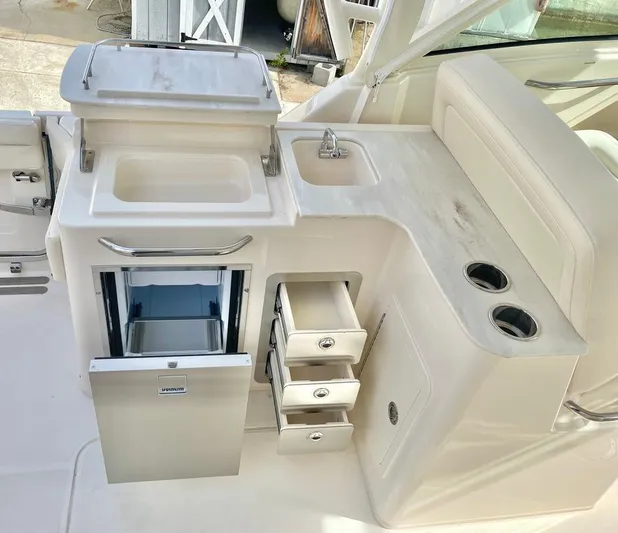  Yacht Photos Pics 2025 Grady-White Freedom 325 boat interior with sink, fridge, and storage drawers.