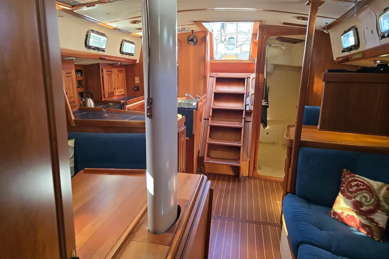 Sail Fourth Yacht Photos Pics Interior of 2001 Tartan 3700 sailboat with wooden furnishings and blue seating.