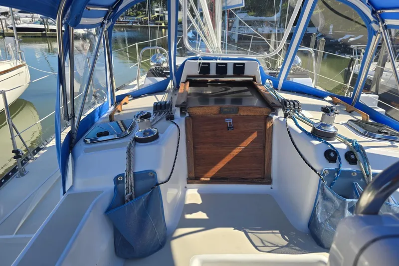 Sail Fourth Yacht Photos Pics Cockpit of 2001 Tartan 3700 sailboat with blue canopy and wooden hatch.