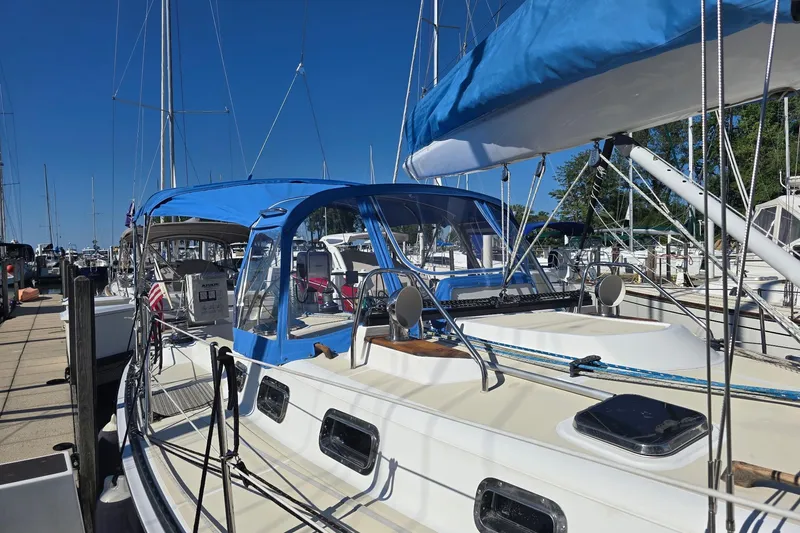 Sail Fourth Yacht Photos Pics Sailboat Tartan 3700, 2001 model, docked with blue canopy and clear skies.