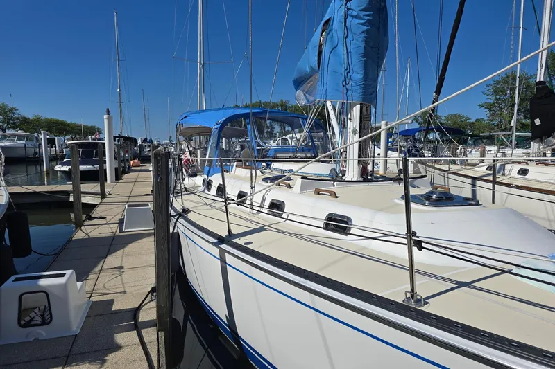Sail Fourth Yacht Photos Pics Sailboat Tartan 3700, 2001 model, docked at marina under clear blue sky.