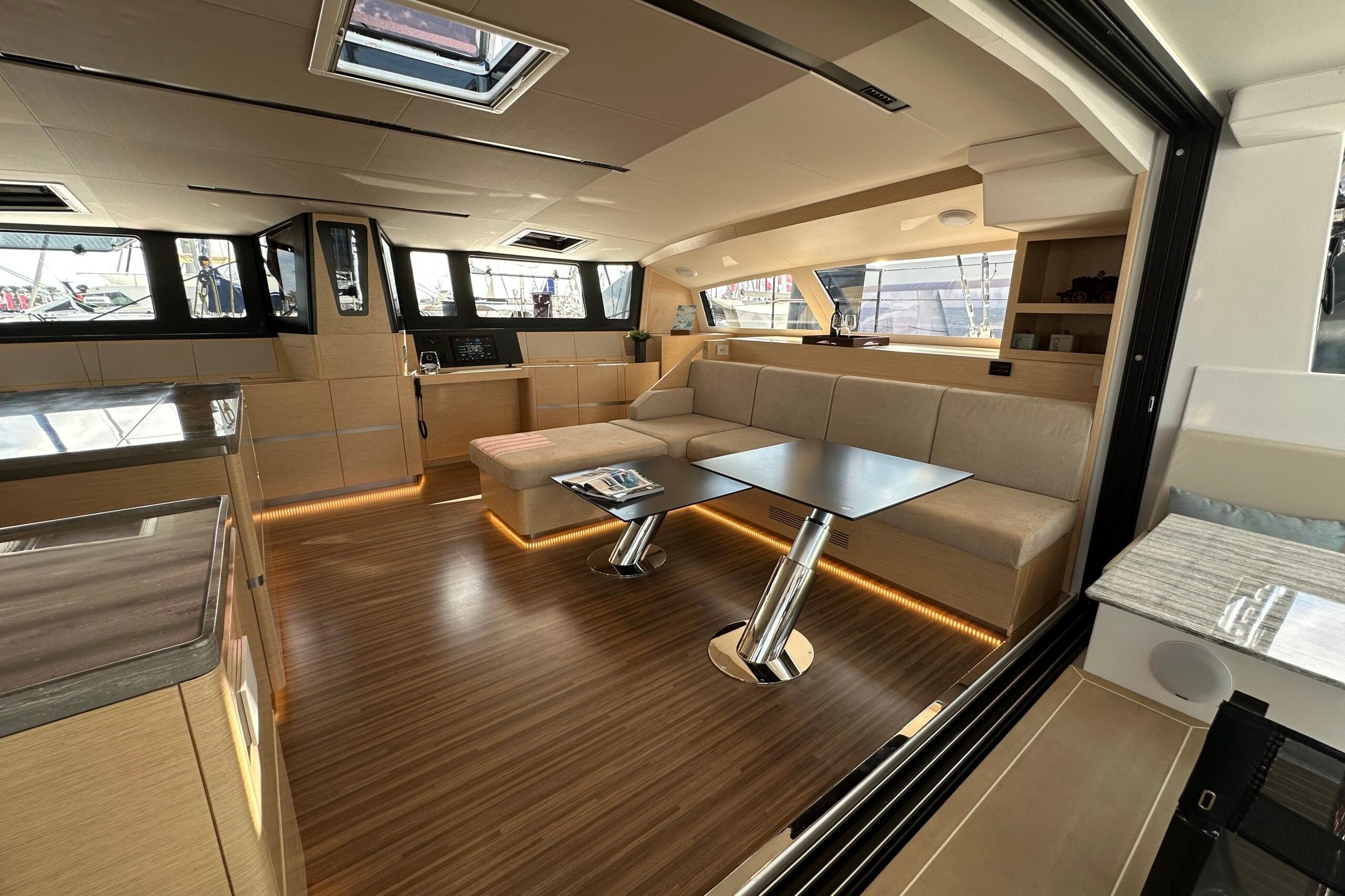 Luxurious interior of 2026 Comar C-CAT 65 catamaran with modern furnishings and ample natural light.