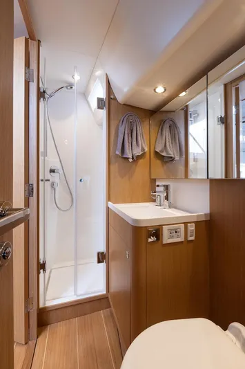 *previous Name Reserved Yacht Photos Pics Luxurious bathroom in 2019 Nautor Swan 48 yacht, featuring modern fixtures and wooden accents.