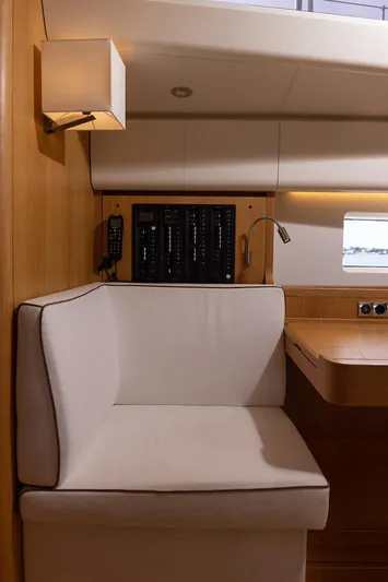 *previous Name Reserved Yacht Photos Pics Interior of 2019 Nautor Swan 48 yacht with cushioned seating and control panel.