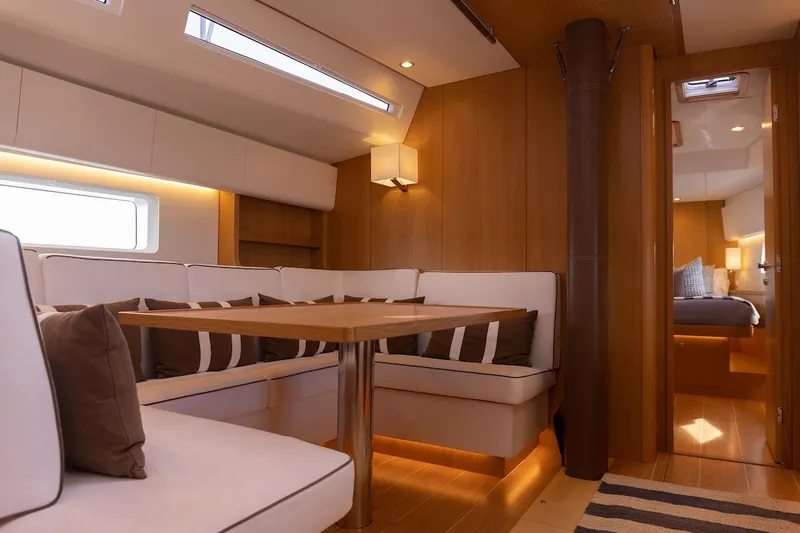*previous Name Reserved Yacht Photos Pics Luxurious interior of 2019 Nautor Swan 48 yacht with elegant seating and wooden finishes.