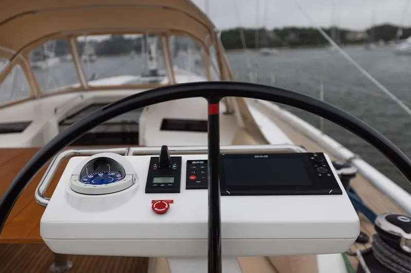 *previous Name Reserved Yacht Photos Pics Steering wheel and control panel of 2019 Nautor Swan 48 yacht, docked in a marina.