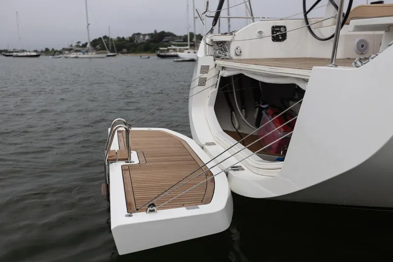 *previous Name Reserved Yacht Photos Pics Nautor Swan 48 yacht, 2019 model, featuring a teak swim platform on calm waters.