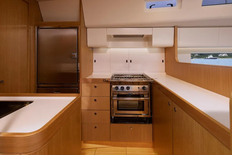 *previous Name Reserved Yacht Photos Pics Modern kitchen interior of 2019 Nautor Swan 48 yacht with wood cabinetry and stainless steel appliances.