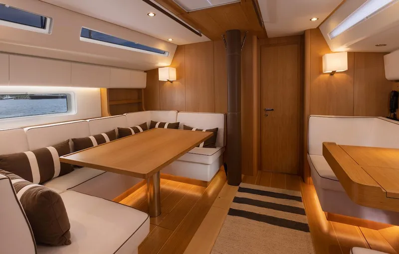 *previous Name Reserved Yacht Photos Pics Luxurious interior of 2019 Nautor Swan 48 yacht with elegant wood finish and cozy seating.
