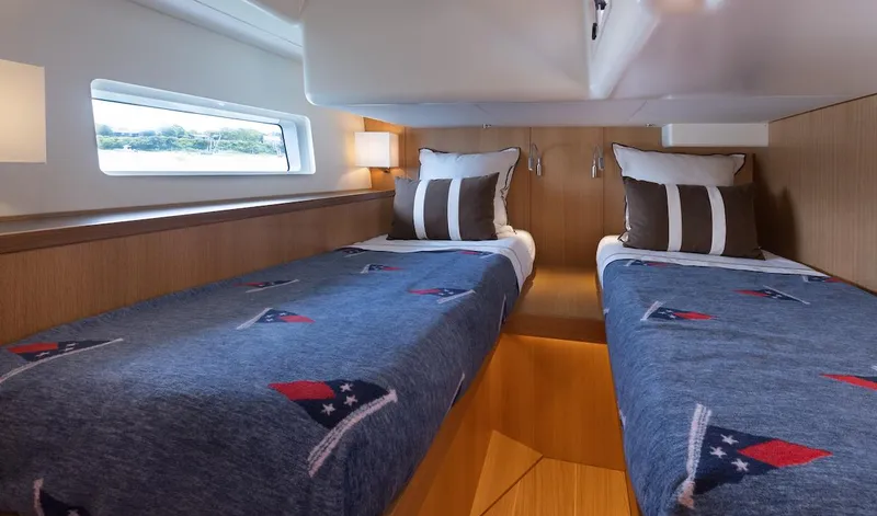 *previous Name Reserved Yacht Photos Pics Interior of 2019 Nautor Swan 48 yacht with twin beds and nautical-themed bedding.