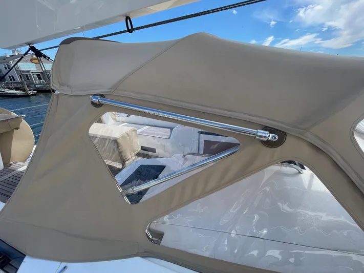 *previous Name Reserved Yacht Photos Pics Nautor Swan 48 yacht cockpit with beige canopy, 2019 model, under clear blue sky.