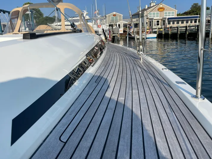 *previous Name Reserved Yacht Photos Pics Nautor Swan 48 yacht deck, 2019 model, docked at a marina with waterfront buildings.