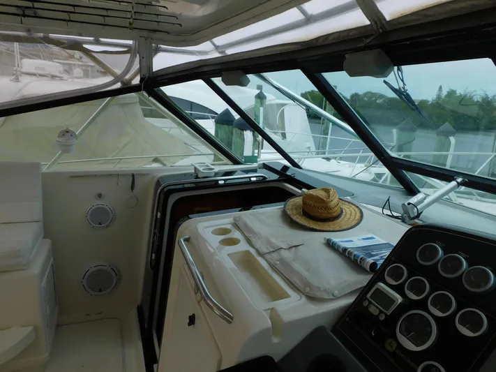 Mad Hatter Yacht Photos Pics 1997 Tiara Yachts Open cockpit with dashboard, straw hat, and magazine.