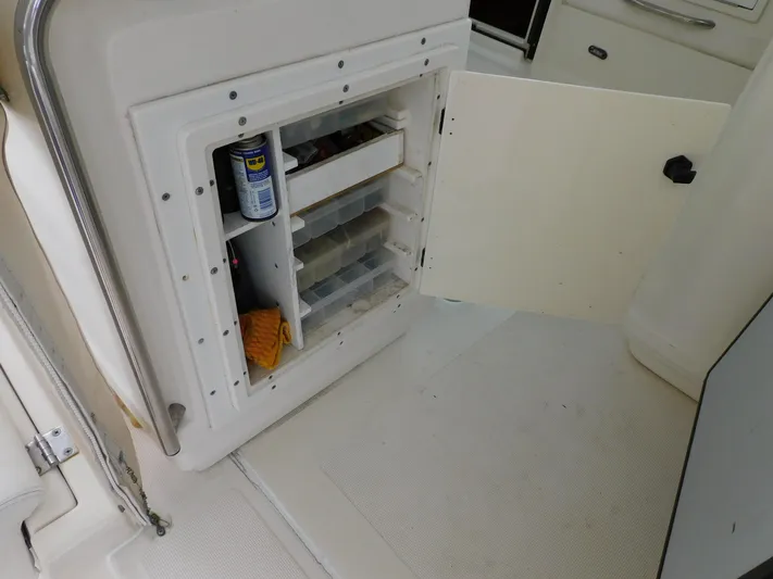 Mad Hatter Yacht Photos Pics 1997 Tiara Yachts Open storage compartment with shelves and cleaning supplies.