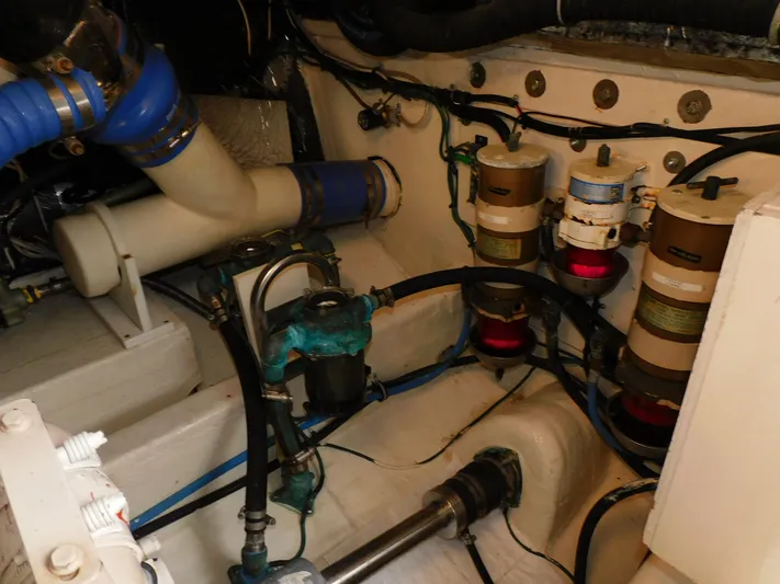 Mad Hatter Yacht Photos Pics Engine room of 1997 Tiara Yachts Open, showcasing filters and piping system.