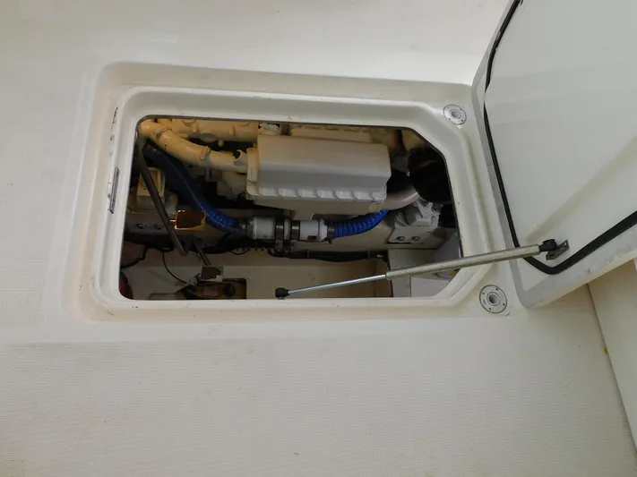 Mad Hatter Yacht Photos Pics Engine compartment of 1997 Tiara Yachts Open, showcasing mechanical components and wiring.