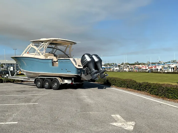  Yacht Photos Pics 2021 Grady-White Freedom 307 boat on trailer in marina parking lot.