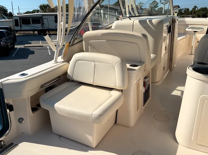  Yacht Photos Pics 2021 Grady-White Freedom 307 boat interior with beige seating and storage compartments.