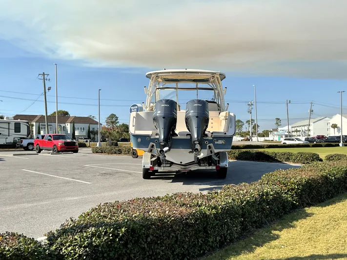  Yacht Photos Pics 2021 Grady-White Freedom 307 boat with dual engines in a parking lot.