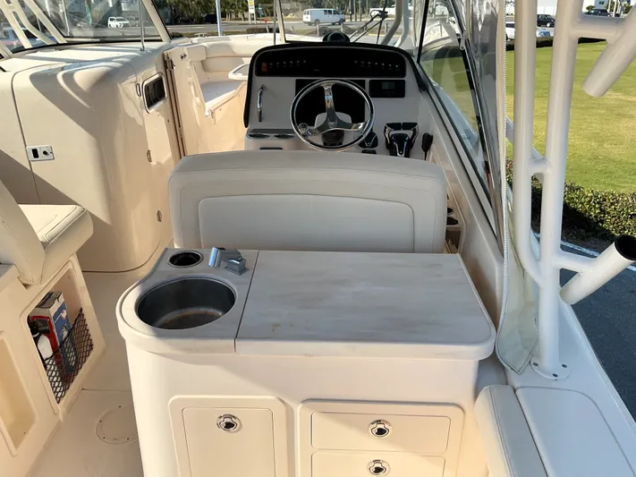  Yacht Photos Pics 2021 Grady-White Freedom 307 boat interior with helm, sink, and storage compartments.
