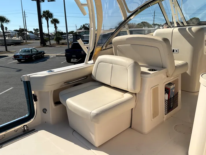  Yacht Photos Pics 2021 Grady-White Freedom 307 boat interior with beige seating and storage compartments.