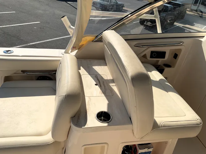  Yacht Photos Pics 2021 Grady-White Freedom 307 boat interior with beige seating and cup holders.