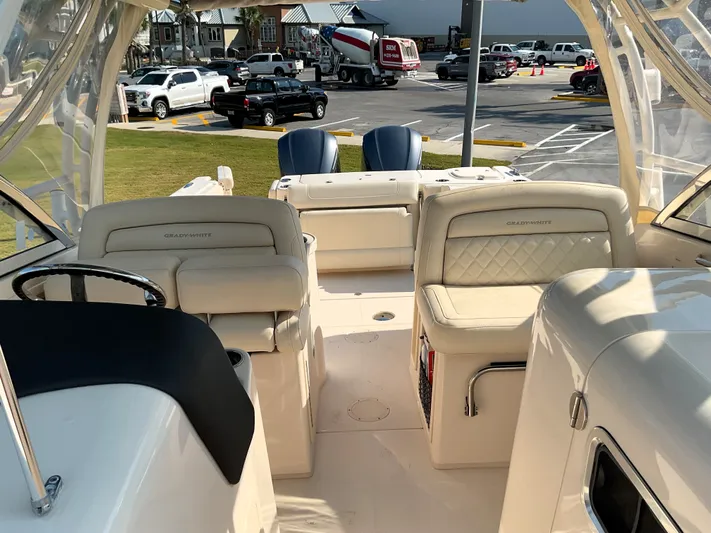  Yacht Photos Pics 2021 Grady-White Freedom 307 boat interior with luxurious seating and steering wheel.