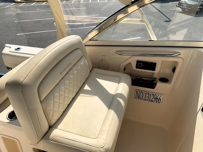  Yacht Photos Pics 2021 Grady-White Freedom 307 boat interior with beige seating and control panel.
