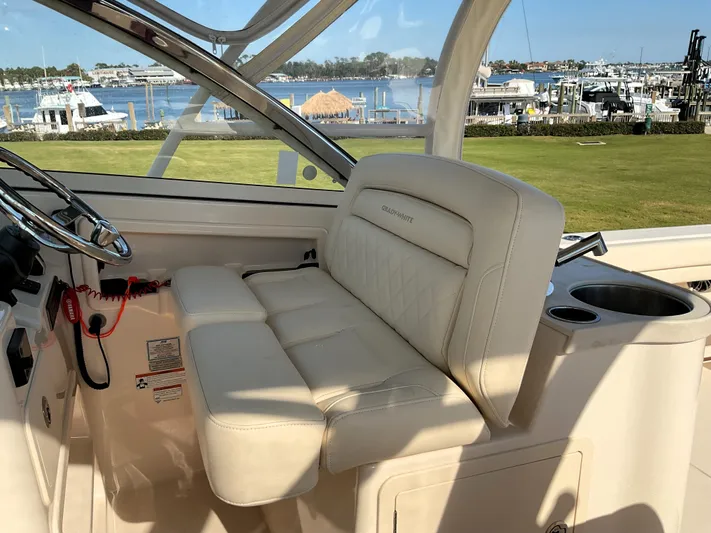  Yacht Photos Pics 2021 Grady-White Freedom 307 boat interior with luxurious seating and scenic marina view.