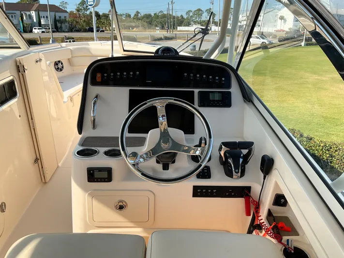  Yacht Photos Pics 2021 Grady-White Freedom 307 boat helm with steering wheel and controls.