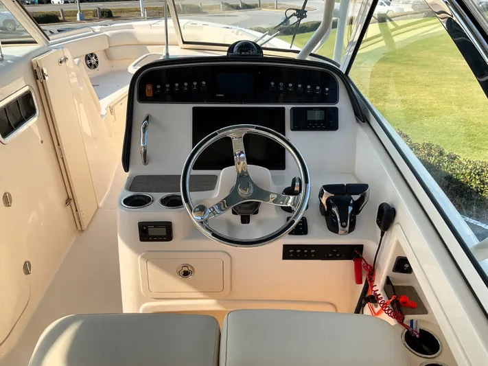  Yacht Photos Pics 2021 Grady-White Freedom 307 boat helm with steering wheel and control panel.