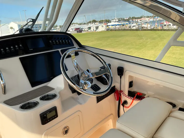  Yacht Photos Pics 2021 Grady-White Freedom 307 boat helm with steering wheel and control panel.