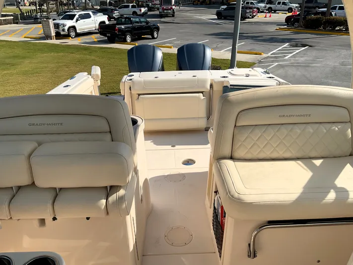 Yacht Photos Pics 2021 Grady-White Freedom 307 boat interior with cushioned seating and dual outboard motors.