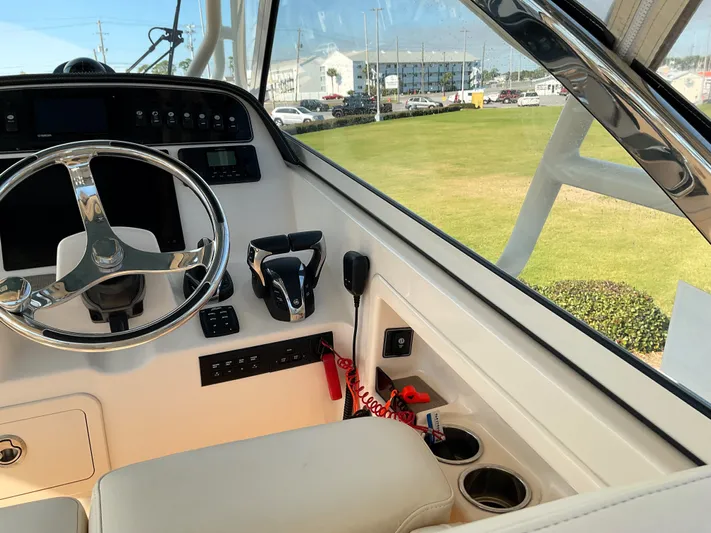  Yacht Photos Pics 2021 Grady-White Freedom 307 boat helm with steering wheel and controls.