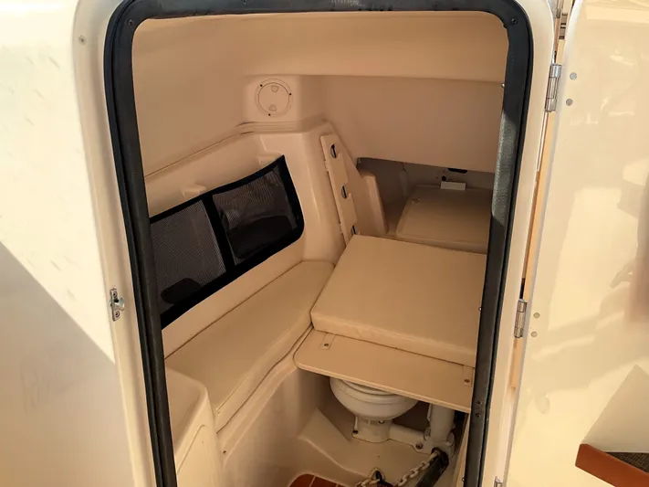  Yacht Photos Pics 2021 Grady-White Freedom 307 boat interior cabin with seating and toilet.