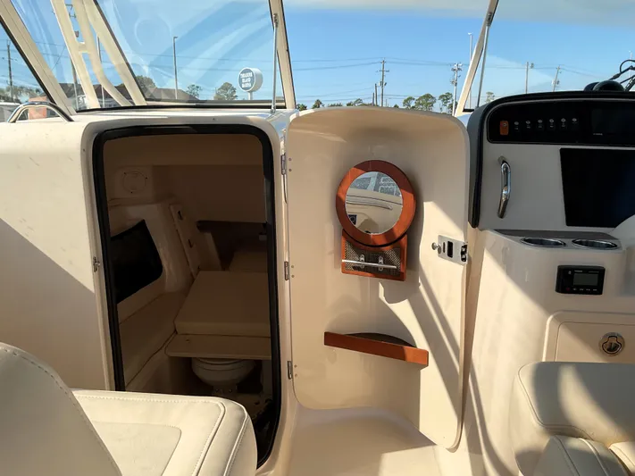  Yacht Photos Pics 2021 Grady-White Freedom 307 boat interior with cabin and helm features.