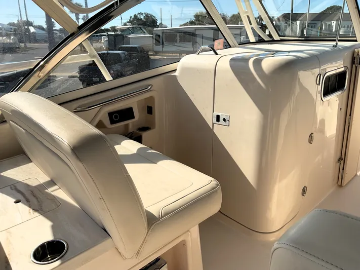  Yacht Photos Pics Interior of 2021 Grady-White Freedom 307 boat with beige seating and console.