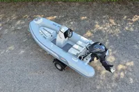 2022 AB Inflatables 11 ALX boat with Yamaha outboard motor on gravel surface.