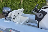 2022 AB Inflatables 11 ALX boat with Yamaha 25 engine, open storage compartment.