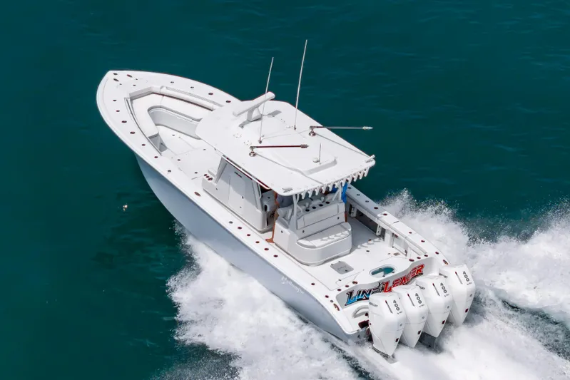 Line Leader Yacht Photos Pics 2024 Yellowfin 39 boat cruising on the water with four outboard engines.