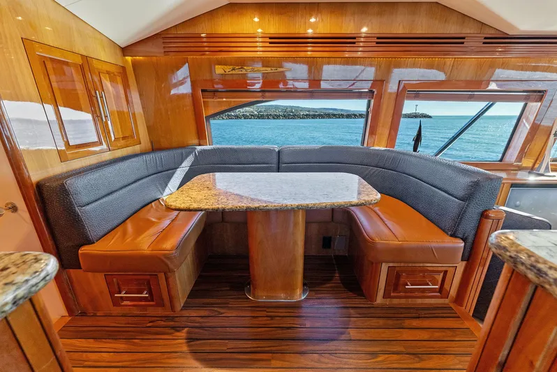 Chupacabra Yacht Photos Pics Luxurious interior of 2007 Hatteras 64 Convertible yacht with elegant dining area.