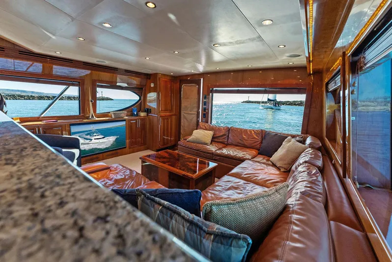 Chupacabra Yacht Photos Pics Luxurious interior of 2007 Hatteras 64 Convertible yacht with ocean view.