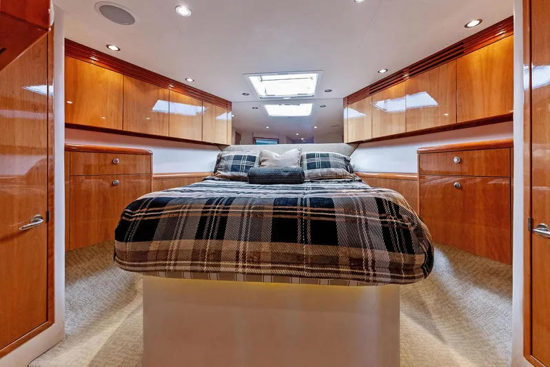 Chupacabra Yacht Photos Pics Luxurious bedroom interior of 2007 Hatteras 64 Convertible yacht with wood cabinetry.