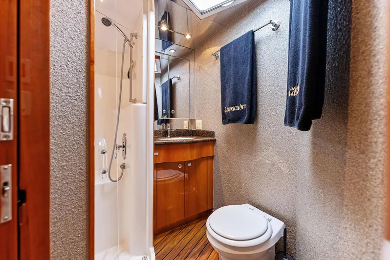 Chupacabra Yacht Photos Pics Bathroom of 2007 Hatteras 64 Convertible yacht with shower, toilet, and vanity.