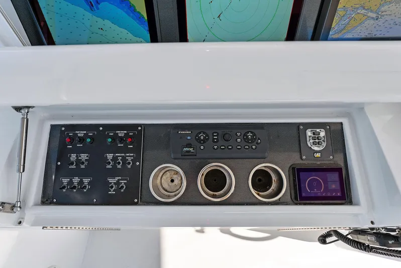 Chupacabra Yacht Photos Pics Control panel of a 2007 Hatteras 64 Convertible yacht with navigation screens.